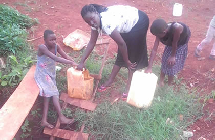 Woman and her kids at unclean well